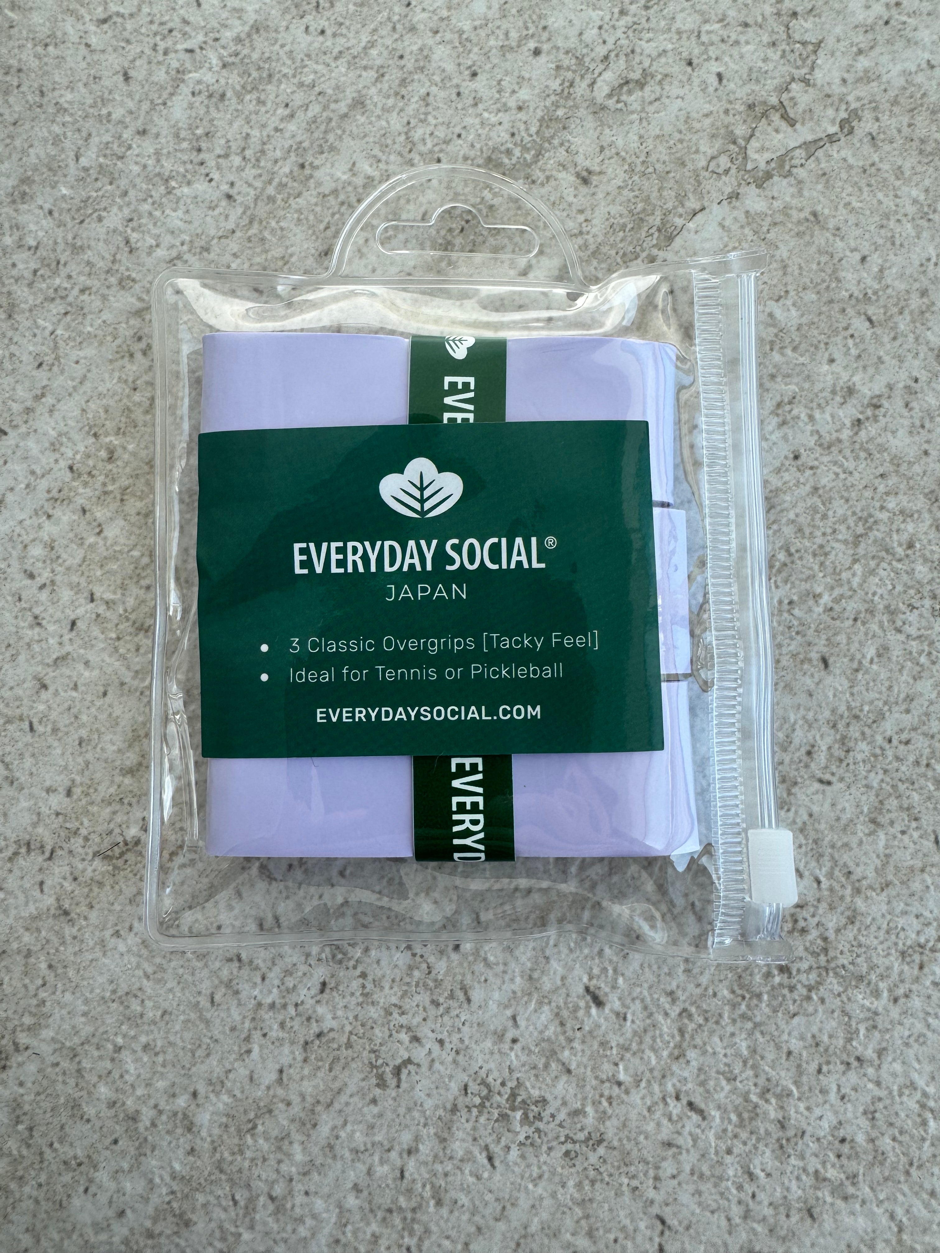 EVERYDAY SOCIAL® Packaged tennis, padel, pickleball overgrips with 'Everyday Social' branding on a marble surface